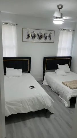 a bedroom with bed and wooden floor