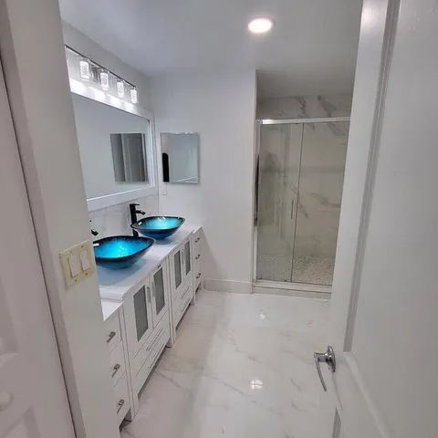 a bathroom with a sink a mirror and vanity