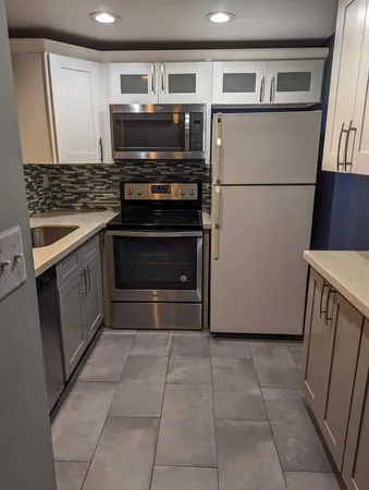 a kitchen with appliances and cabinets