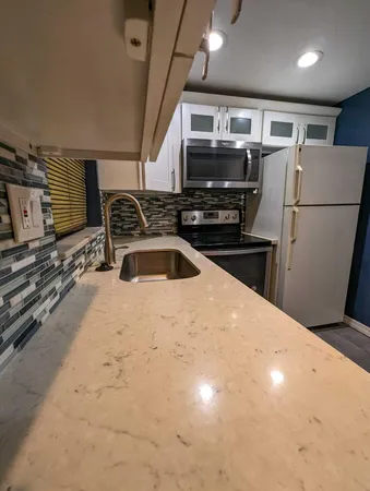 a kitchen with a sink and a refrigerator