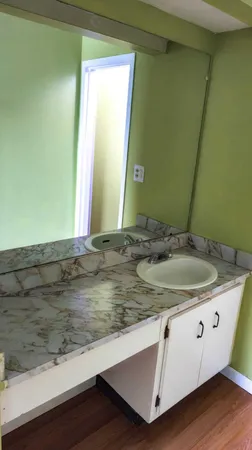 a view of a room with wooden floor and a floor to ceiling window