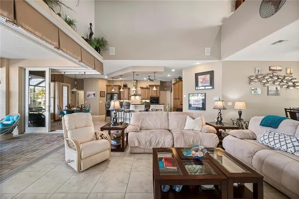 a living room with furniture and a floor to ceiling window