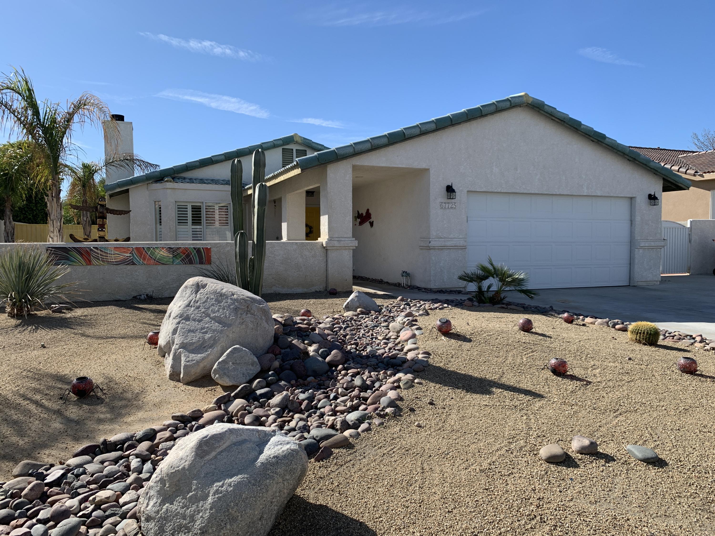 67725 Garbino Road Cathedral City, CA 92234 - Photo 1 of 16 a front view of a house with patio