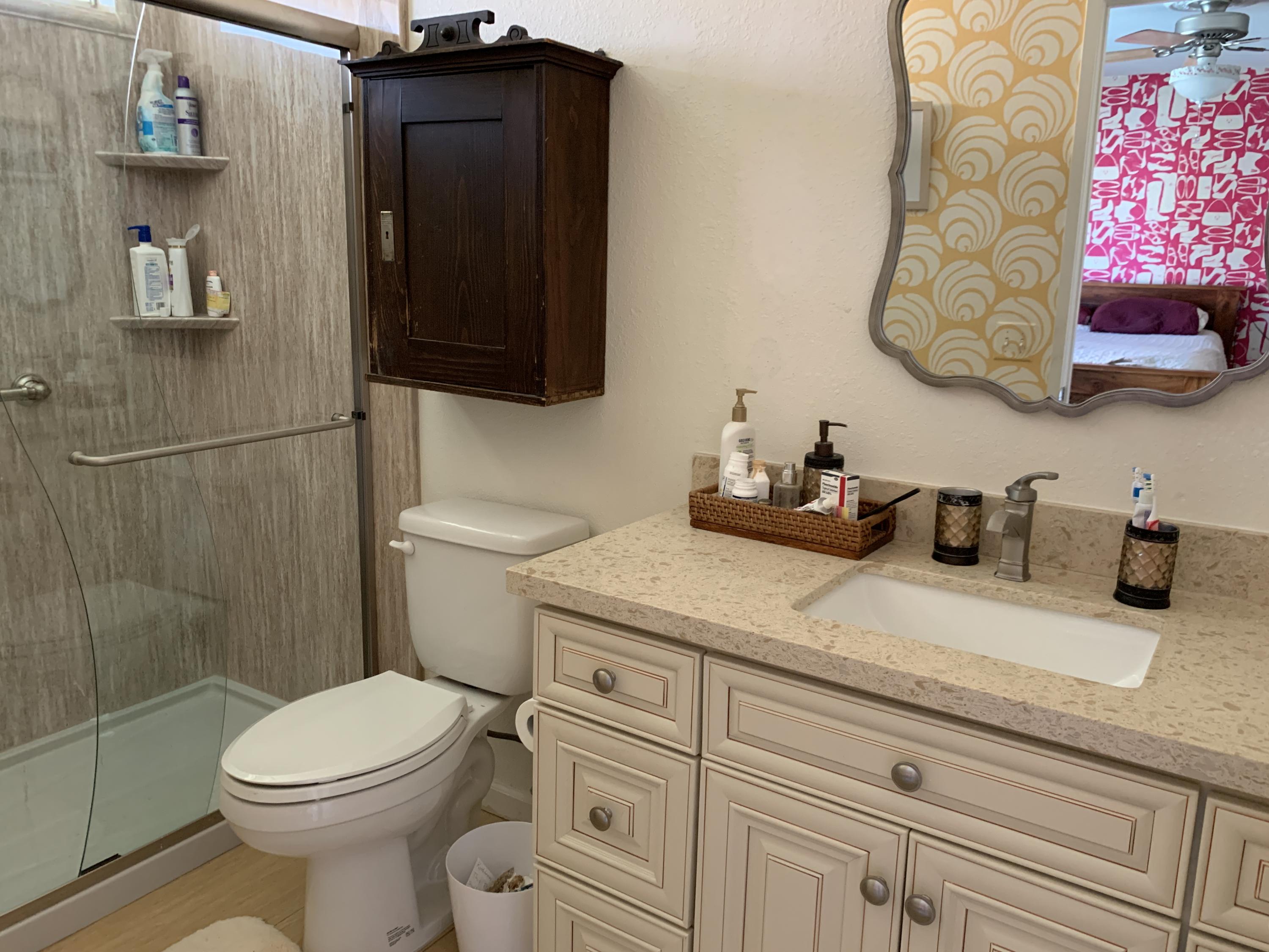 67725 Garbino Road Cathedral City, CA 92234 - Photo 4 of 16 a bathroom with a granite countertop toilet sink and mirror