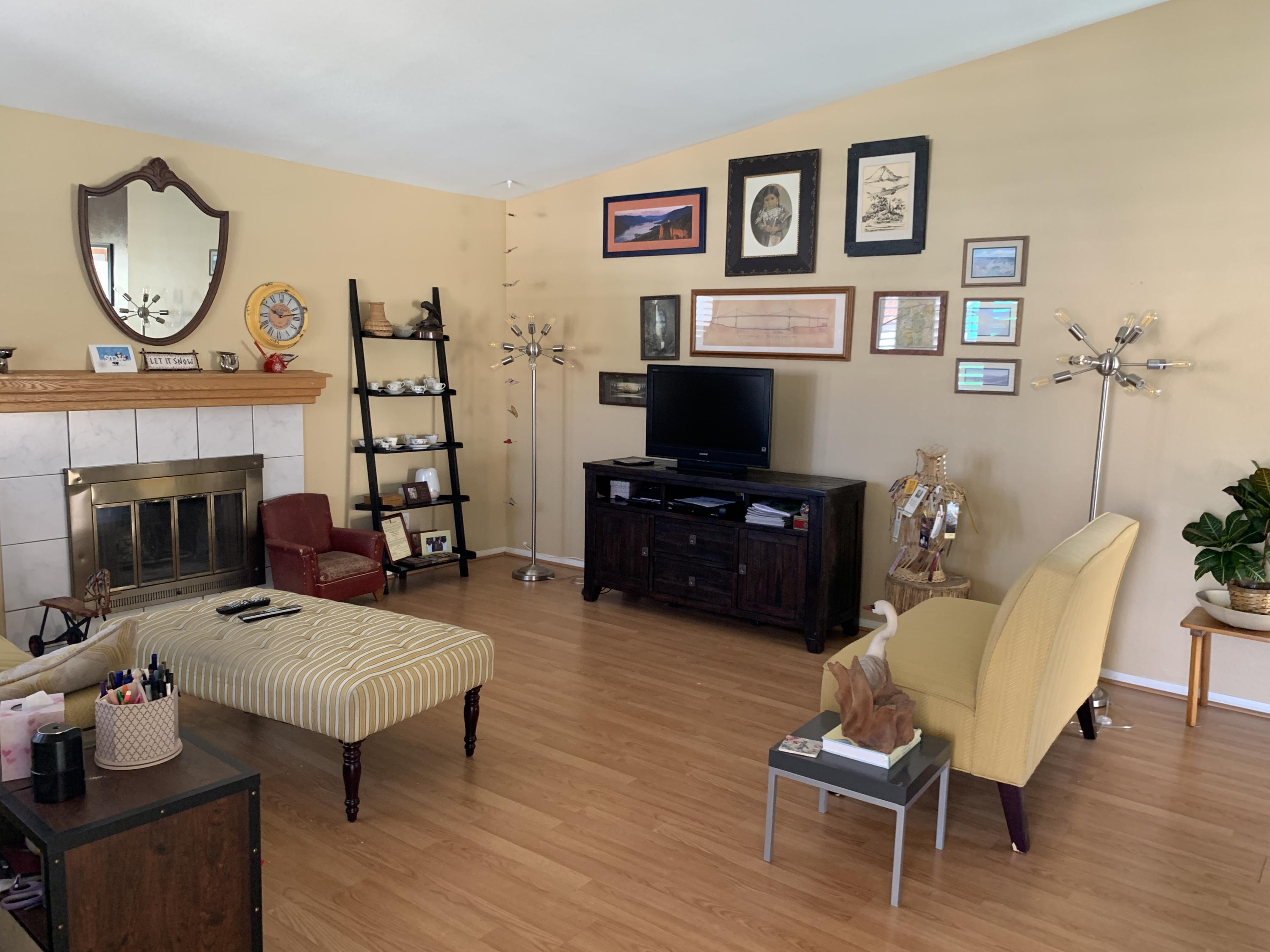67725 Garbino Road Cathedral City, CA 92234 - Photo 10 of 16 a living room with furniture a fireplace and a flat screen tv
