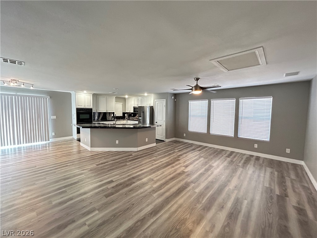 6538 Elm Spring Las Vegas, NV 89148 - Photo 28 of 29 An open floorplan seamlessly connects the kitchen with a spacious living area, ideal for gathering.