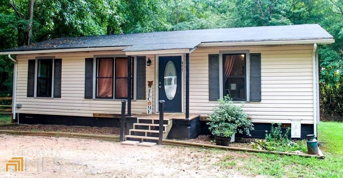 a view of a house with a yard and sitting space