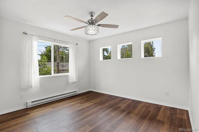 a view of an empty room with wooden floor