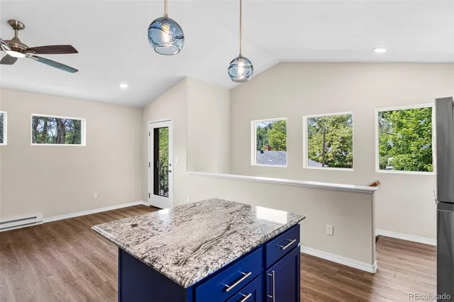 a kitchen with stainless steel appliances granite countertop a sink refrigerator and microwave