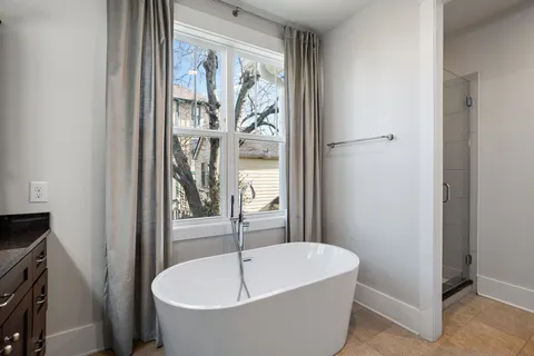a bathroom with a tub and shower