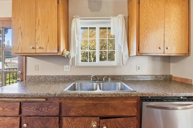 a kitchen with granite countertop a sink and a stove