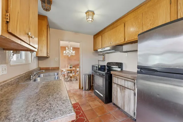 a kitchen with stainless steel appliances granite countertop a sink stove and cabinets