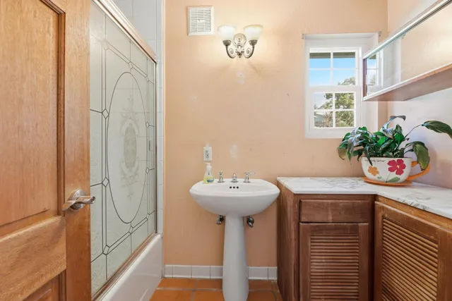 a bathroom with a sink a mirror and a shower