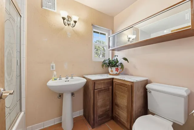 a bathroom with a sink toilet and a mirror