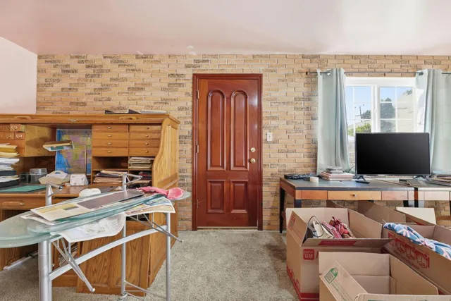 a work place with a couch and a flat screen tv