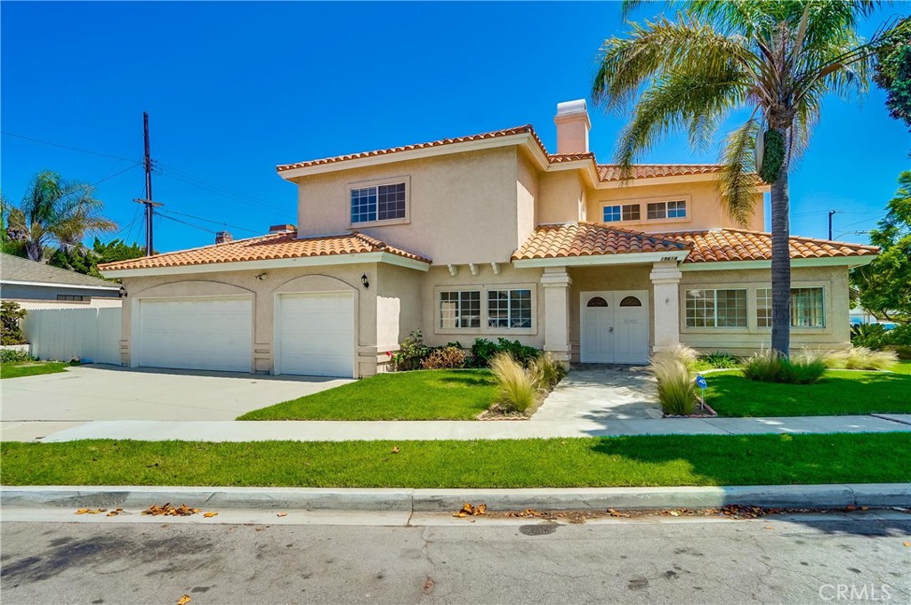 19614 Darien Place Torrance, CA 90503 - Photo 1 of 2 a view of a white house with a yard and plants next to a road