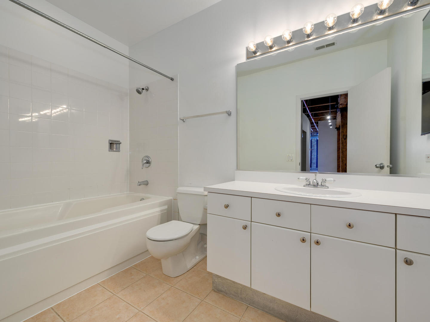 375 West Erie Street, Unit 508 Chicago, IL 60654 - Photo 13 of 16 a bathroom with a toilet a sink a tub and mirror