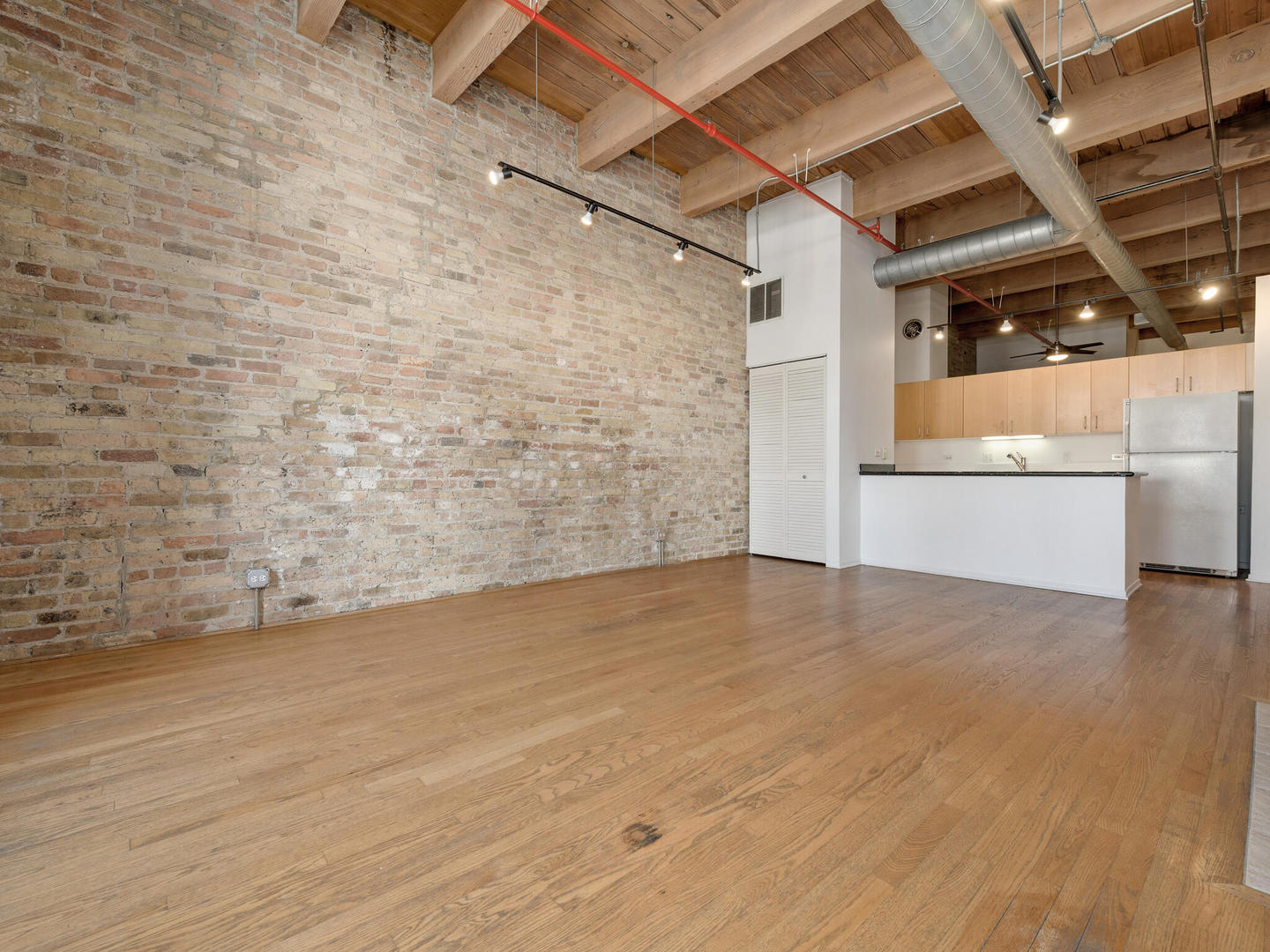 375 West Erie Street, Unit 508 Chicago, IL 60654 - Photo 5 of 16 an empty room with wooden floor and windows