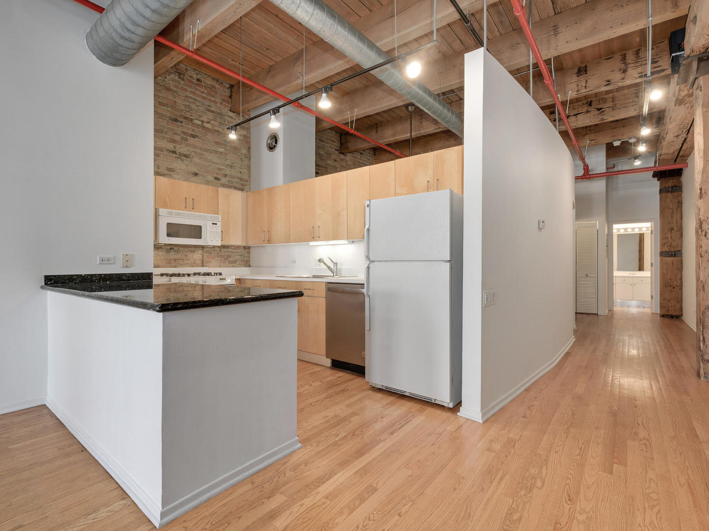 375 West Erie Street, Unit 508 Chicago, IL 60654 - Photo 7 of 16 a kitchen with kitchen island wooden floors appliances and cabinets