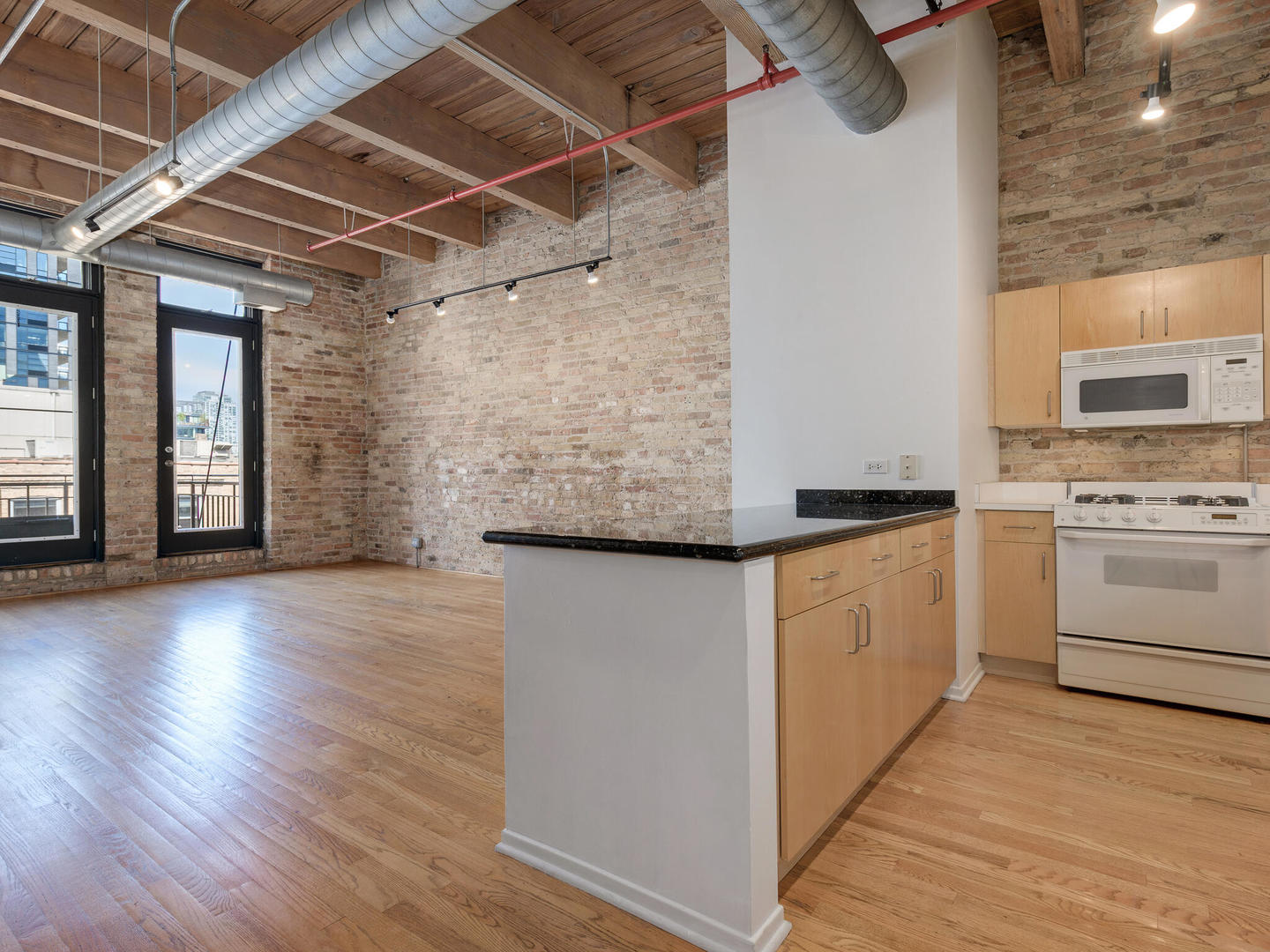 375 West Erie Street, Unit 508 Chicago, IL 60654 - Photo 8 of 16 a view of kitchen with cabinets and wooden floor