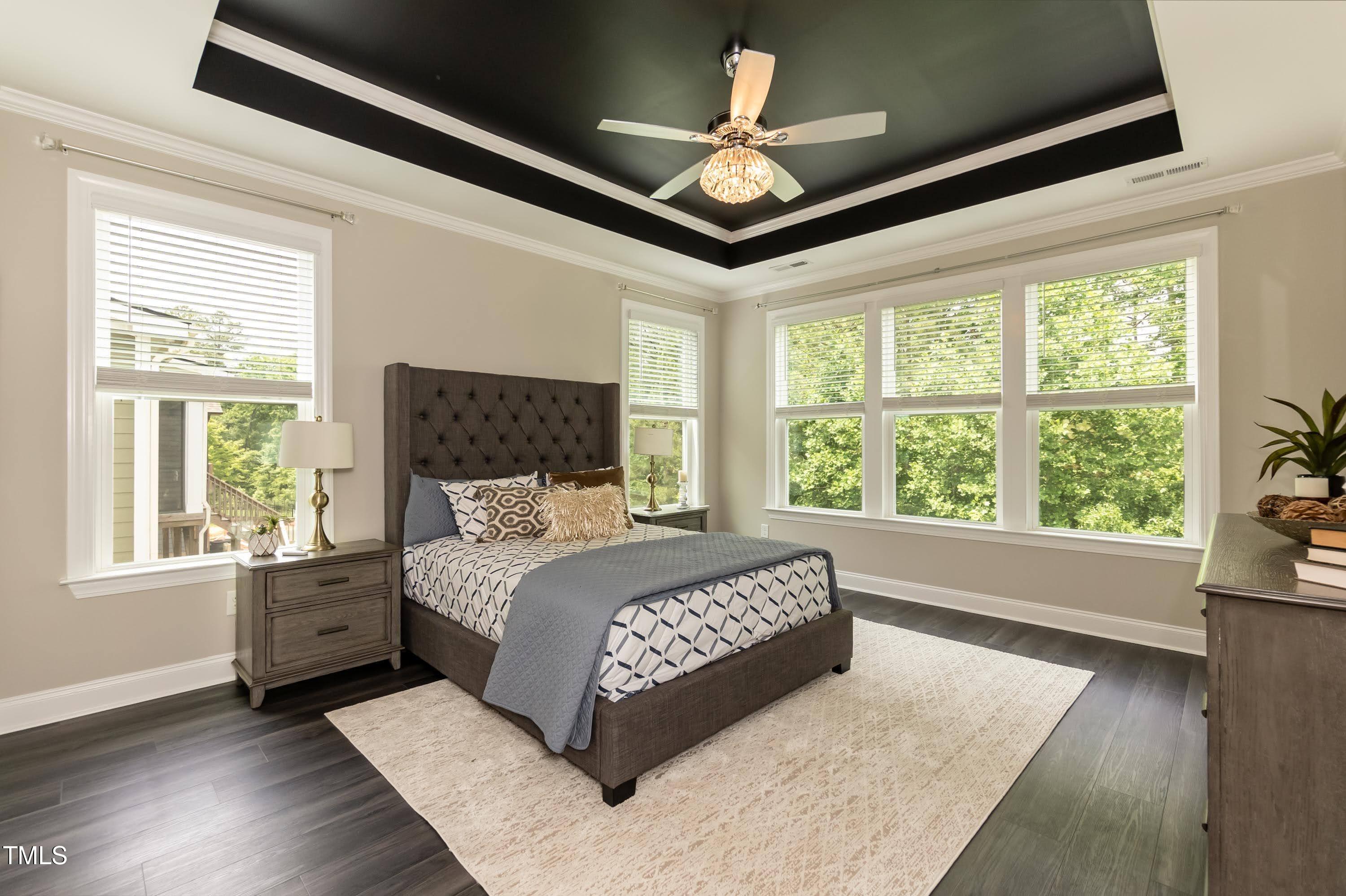 273 Scarlet Tanager Circle Holly Springs, NC 27540 - Photo 17 of 35 a spacious bedroom with a large bed and a large window