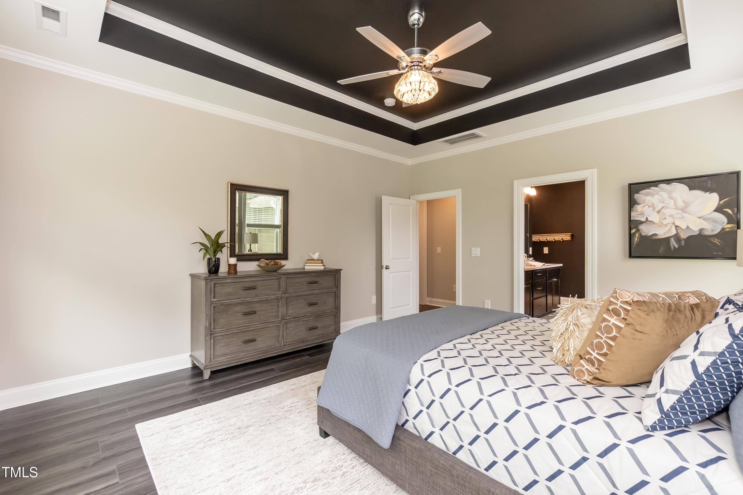 273 Scarlet Tanager Circle Holly Springs, NC 27540 - Photo 18 of 35 a bedroom with a bed and a dresser