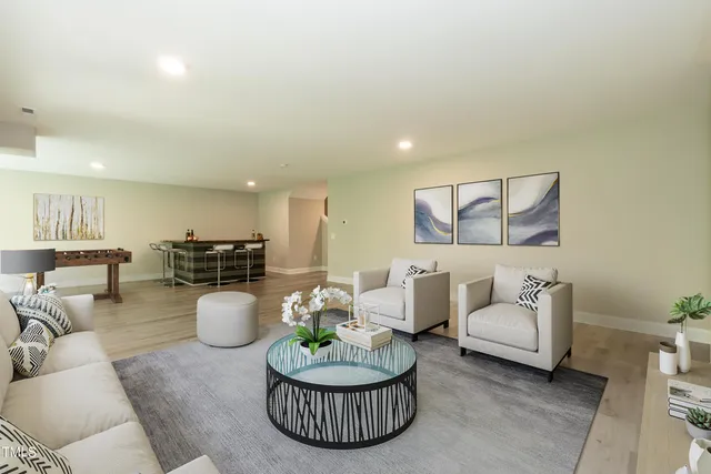a living room with furniture and a wooden floor