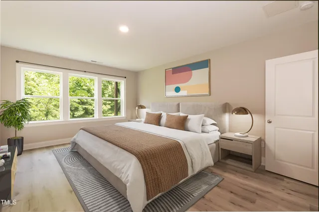 a bedroom with bed and a large window