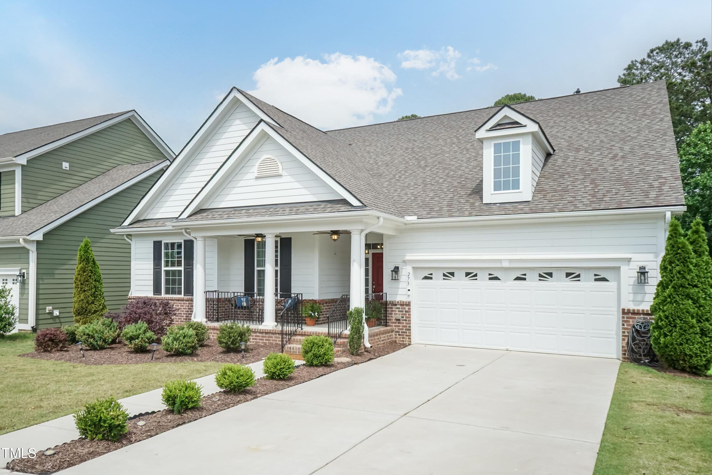 273 Scarlet Tanager Circle Holly Springs, NC 27540 - Photo 3 of 35 a view of a house with a yard and potted plants