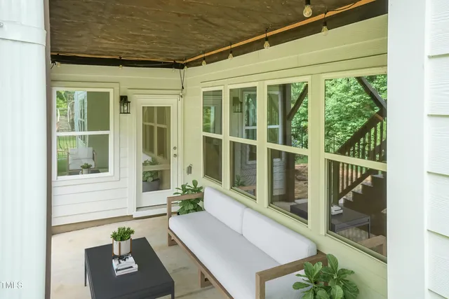 a front view of a house with a potted plant