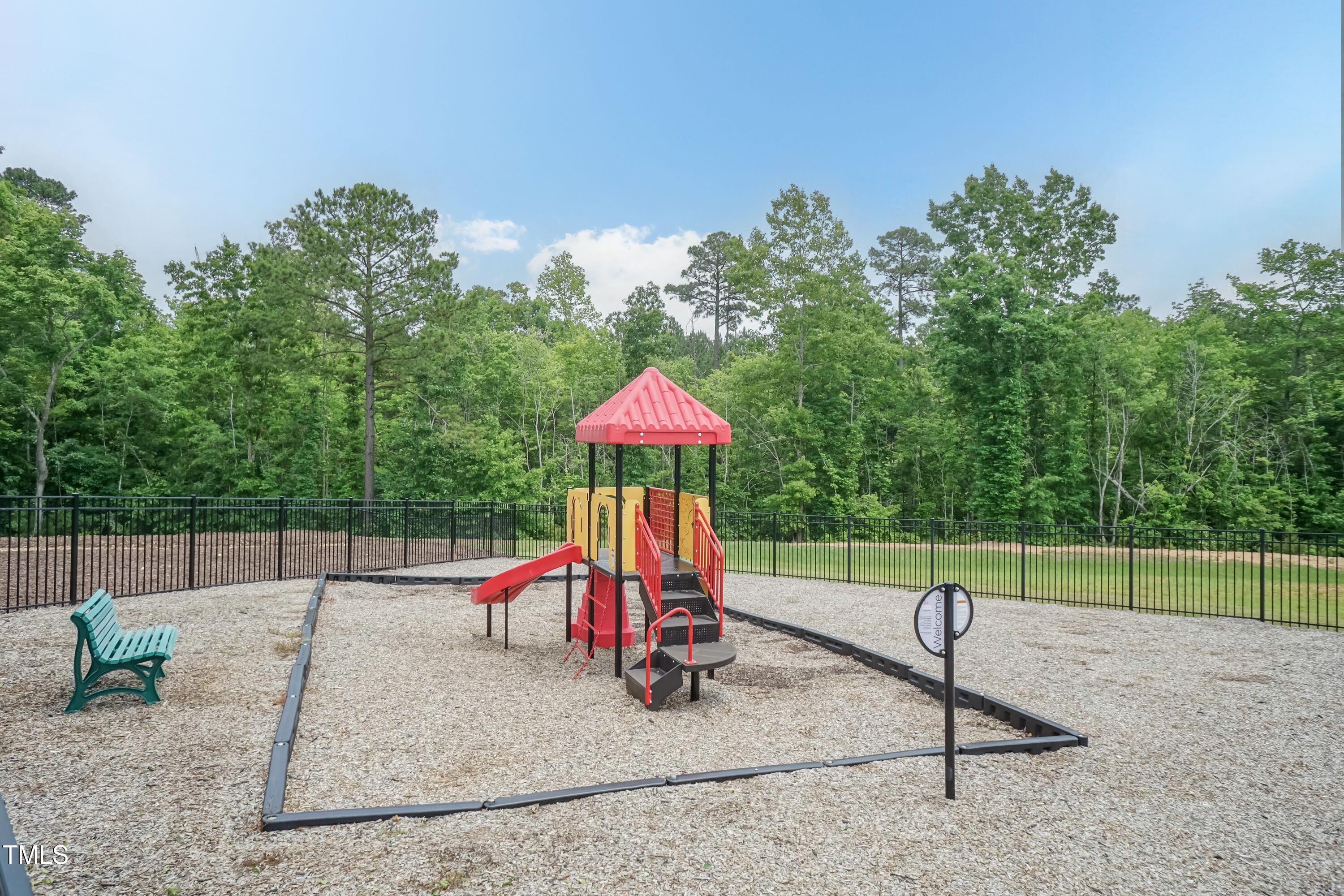 273 Scarlet Tanager Circle Holly Springs, NC 27540 - Photo 34 of 35 a park with a slide and swing