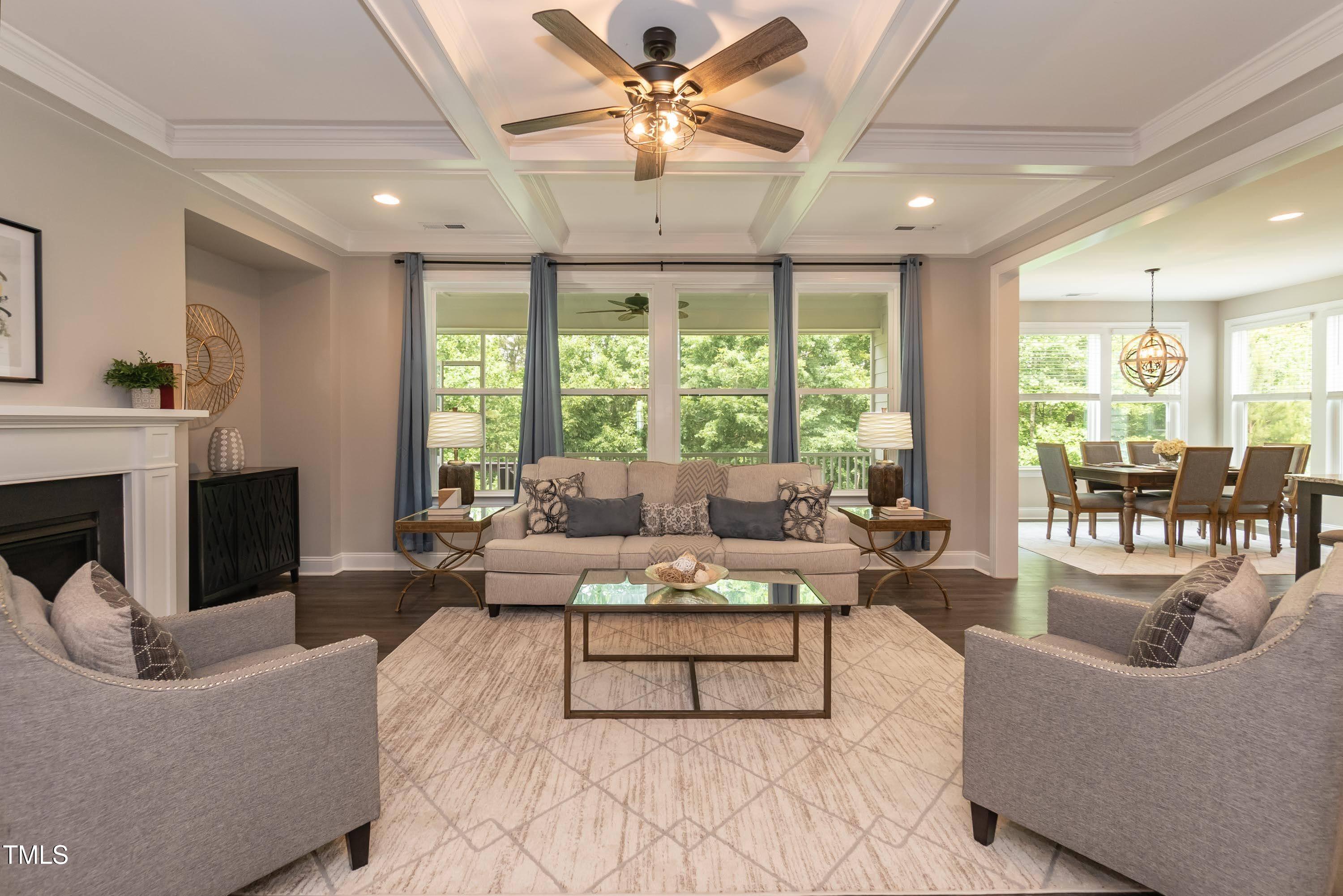 273 Scarlet Tanager Circle Holly Springs, NC 27540 - Photo 5 of 35 a living room with furniture fireplace and a large window