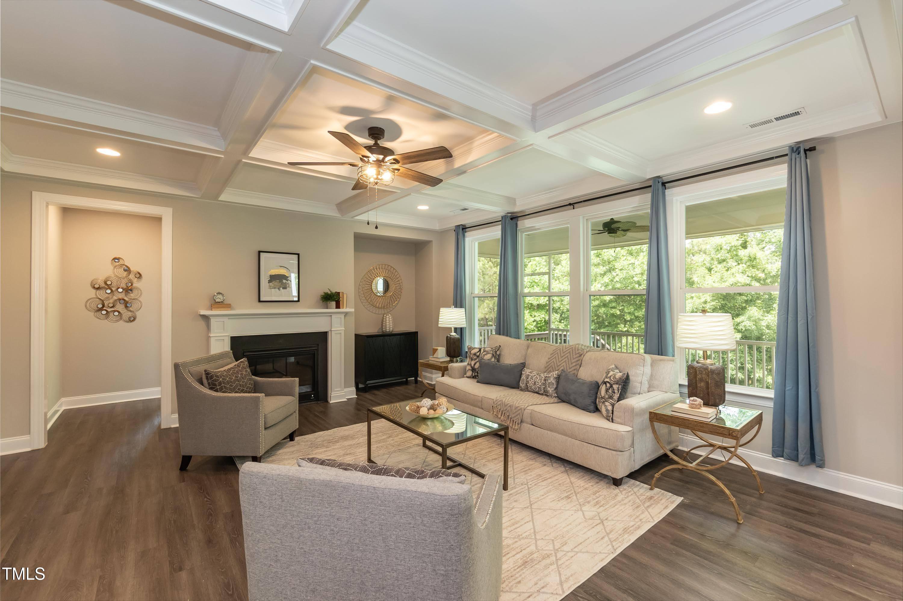 273 Scarlet Tanager Circle Holly Springs, NC 27540 - Photo 6 of 35 a living room with furniture and a fireplace