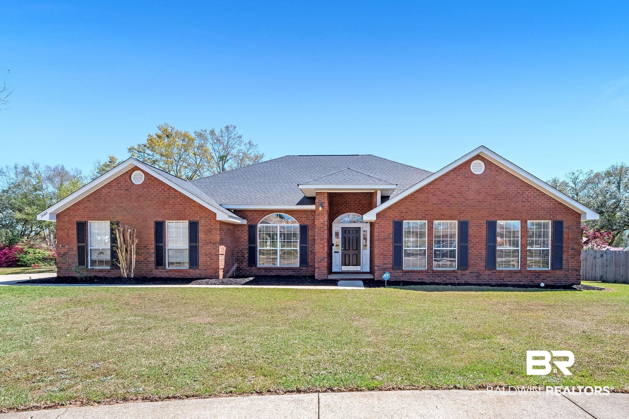 16444 Hamlet Lane Foley, AL 36535 - Photo 1 of 49 View of front facade featuring brick siding, a front yard, a shingled roof, and fence