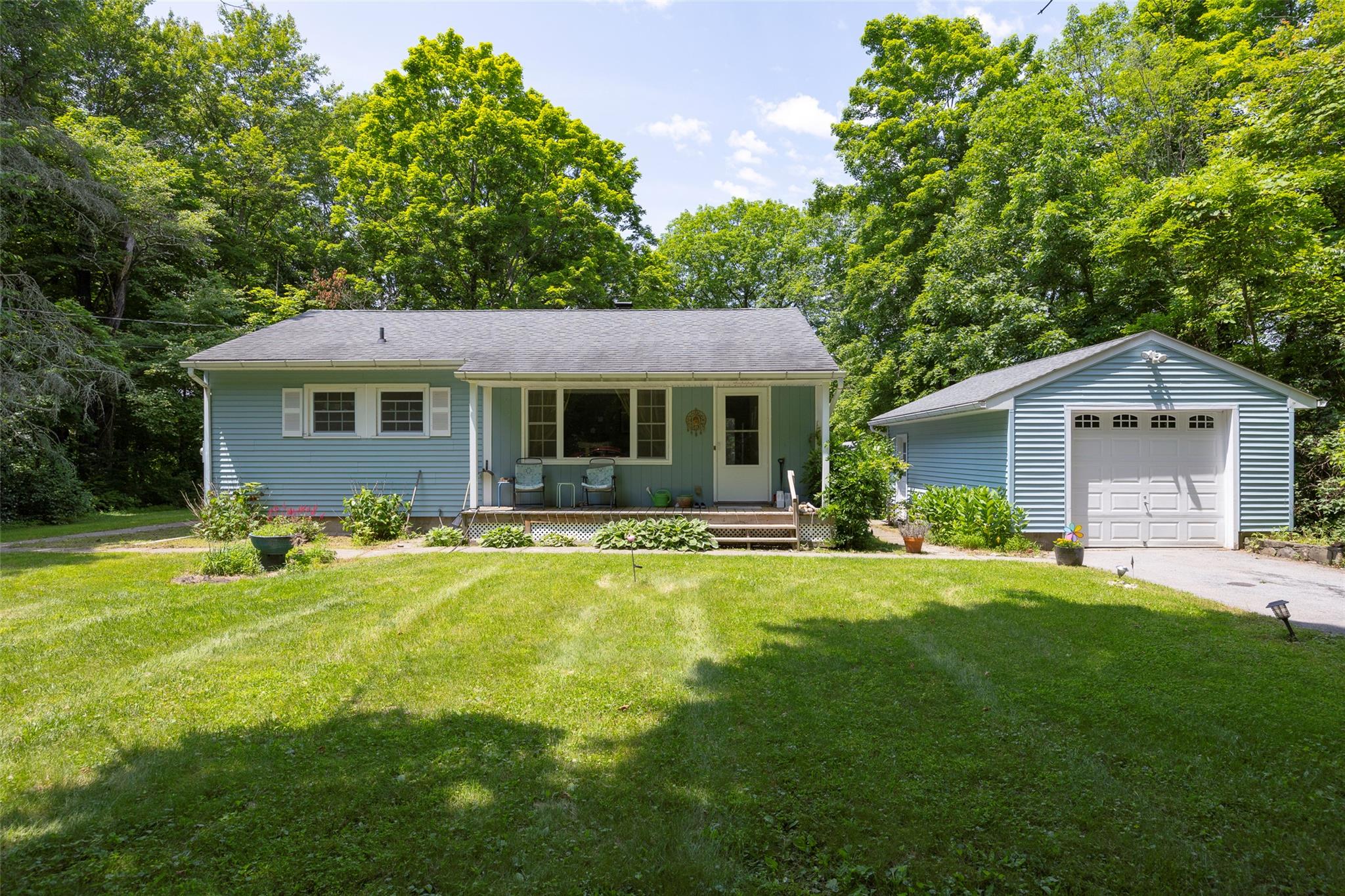 a front view of house with yard and green space