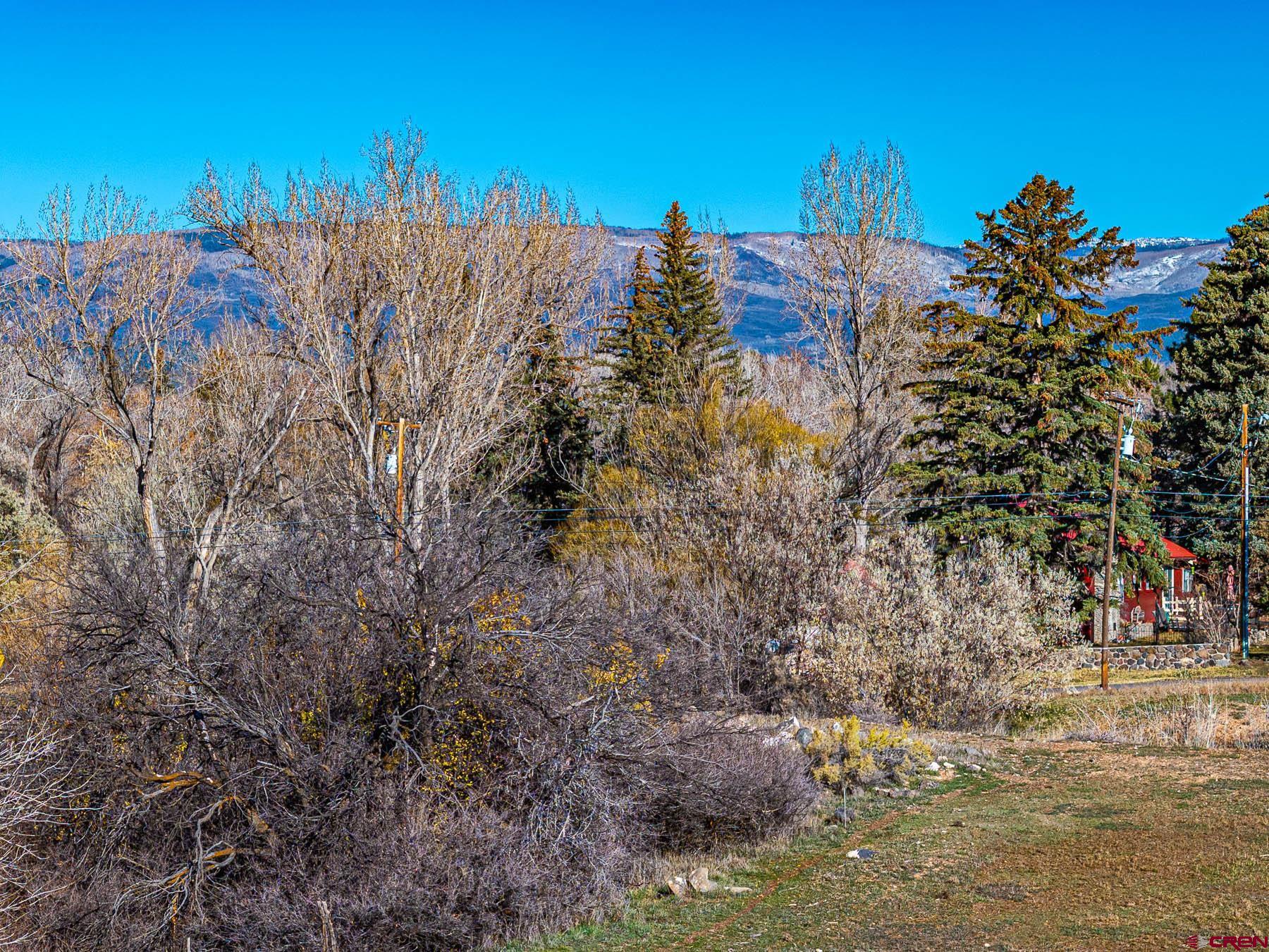 520 Southeast Stonebridge Drive Cedaredge, CO 81413 - Photo 9 of 15 a view of a lake with a building in the background