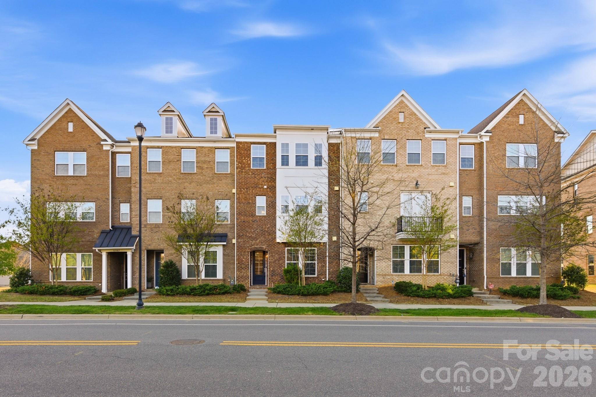 a front view of a residential apartment building with a yard