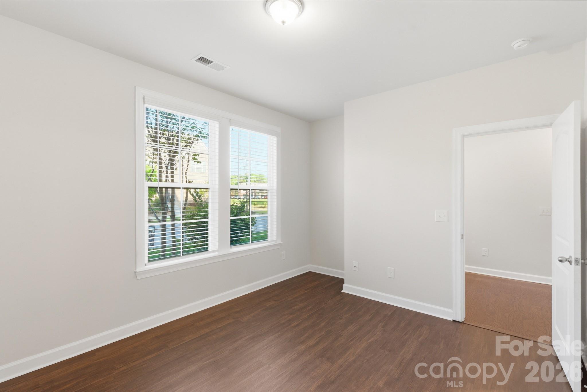 11515 Red Rust Lane Charlotte, NC 28277 - Photo 11 of 48 an empty room with wooden floor and windows