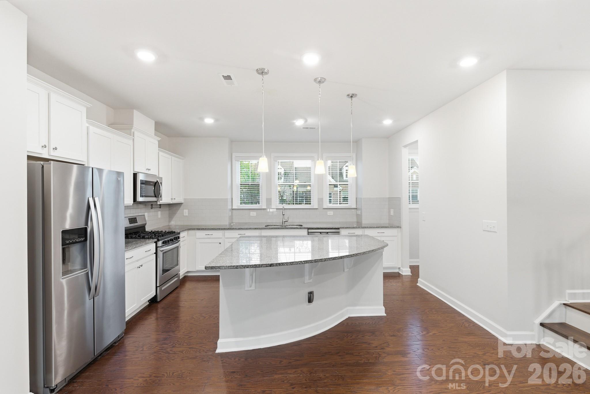 11515 Red Rust Lane Charlotte, NC 28277 - Photo 17 of 48 a large kitchen with stainless steel appliances kitchen island granite countertop a refrigerator and a sink