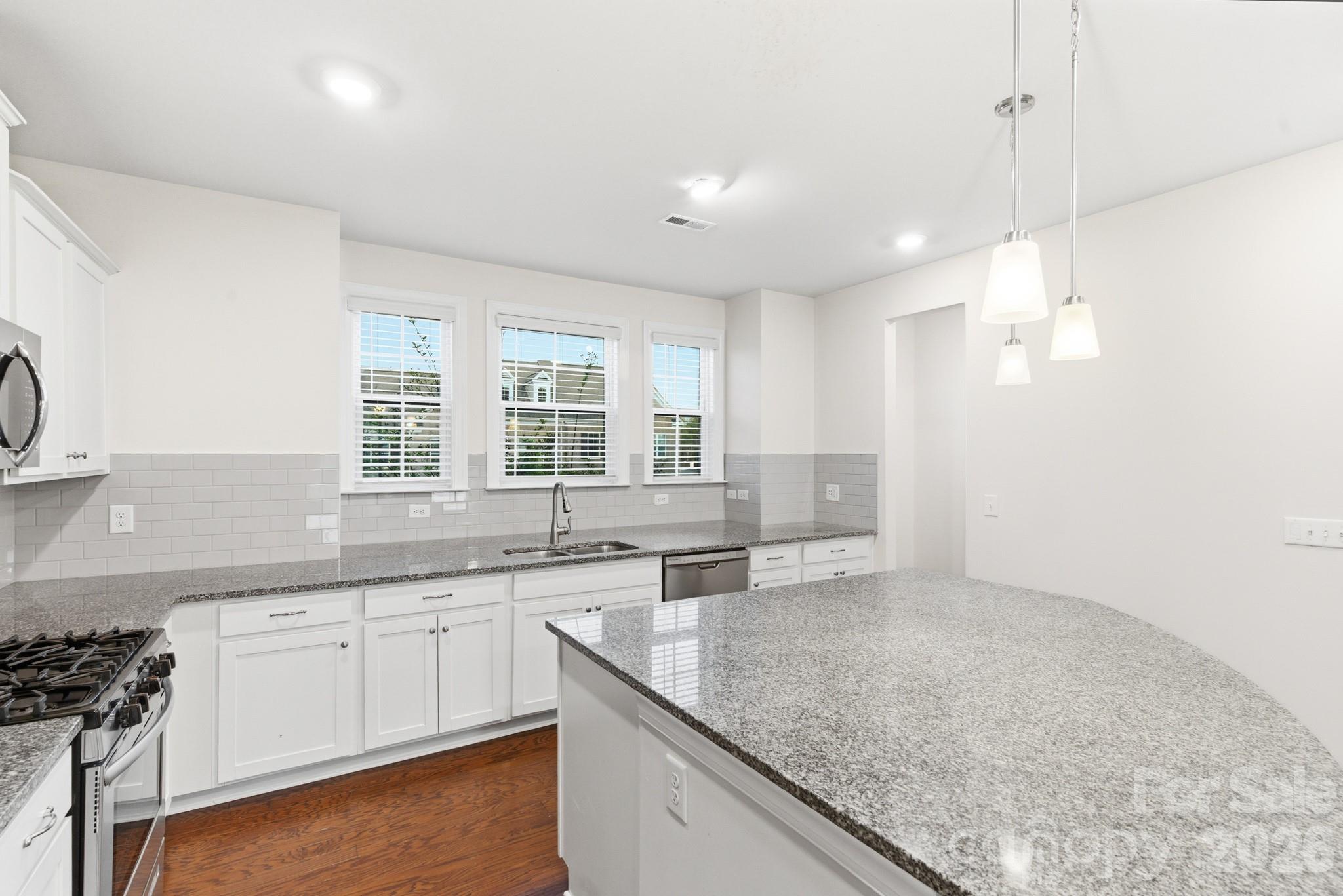11515 Red Rust Lane Charlotte, NC 28277 - Photo 18 of 48 a kitchen with a sink stove and cabinets