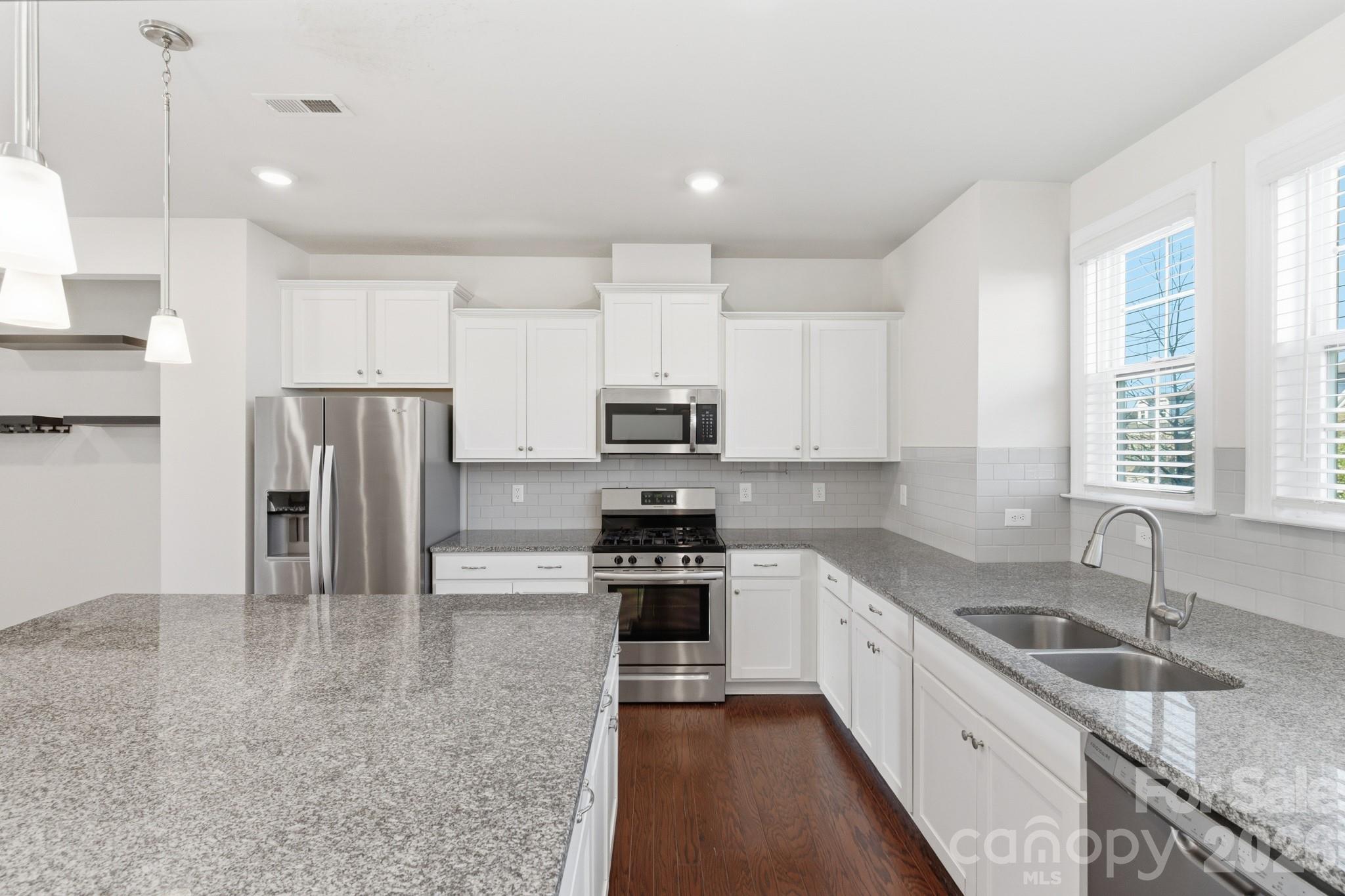 11515 Red Rust Lane Charlotte, NC 28277 - Photo 19 of 48 a kitchen with granite countertop a refrigerator sink and cabinets