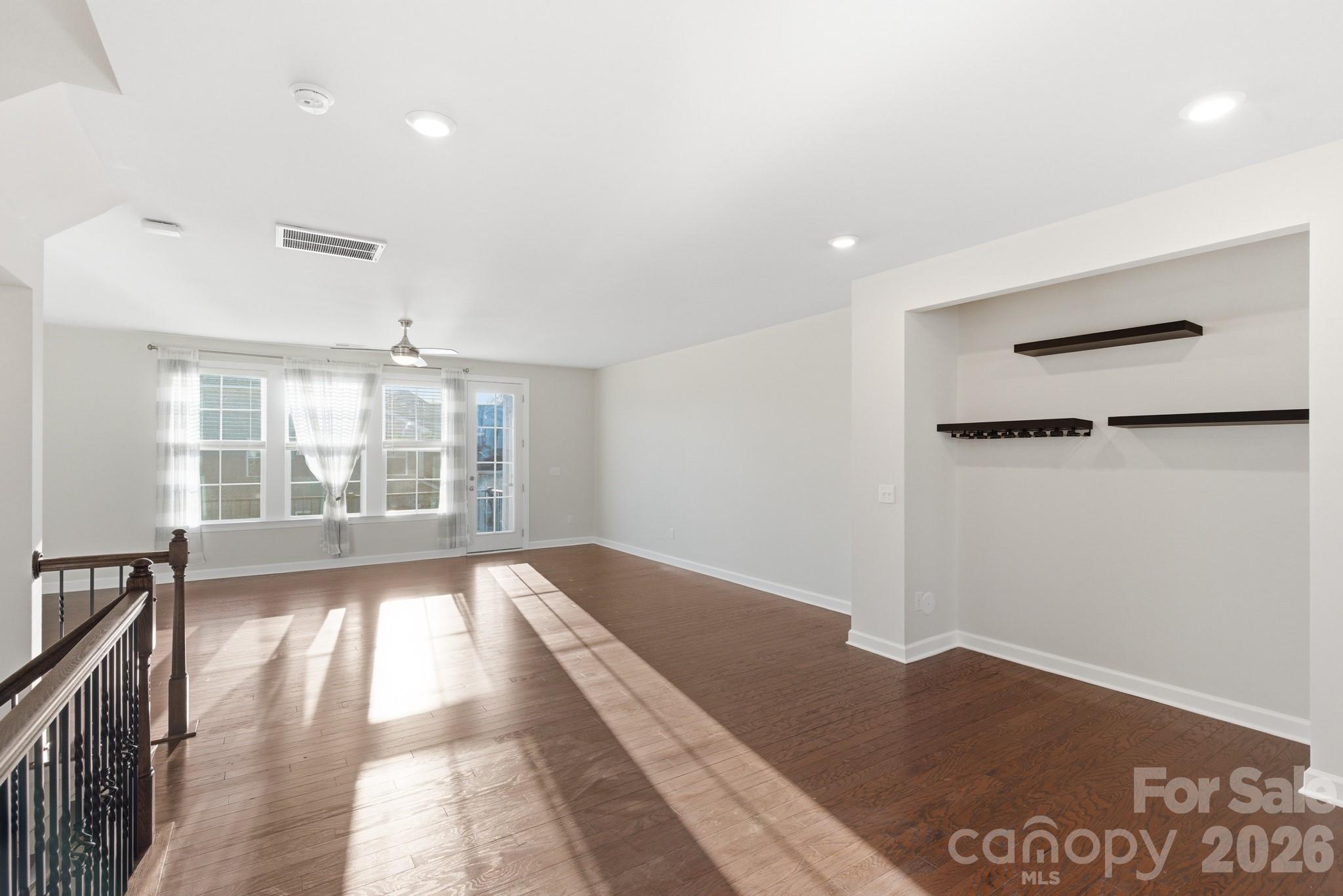 11515 Red Rust Lane Charlotte, NC 28277 - Photo 21 of 48 a view of empty room with wooden floor and fan