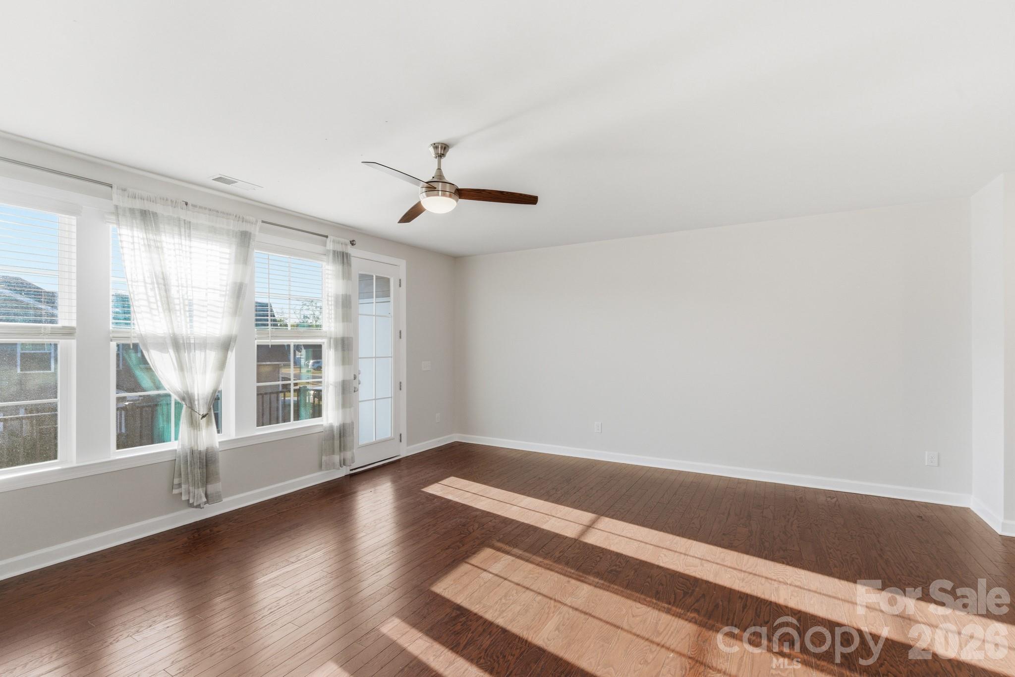 11515 Red Rust Lane Charlotte, NC 28277 - Photo 24 of 48 a view of empty room with wooden floor and fan