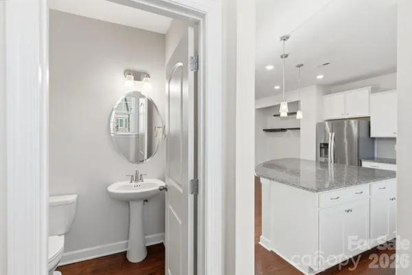 a bathroom with a granite countertop sink a mirror and a shower