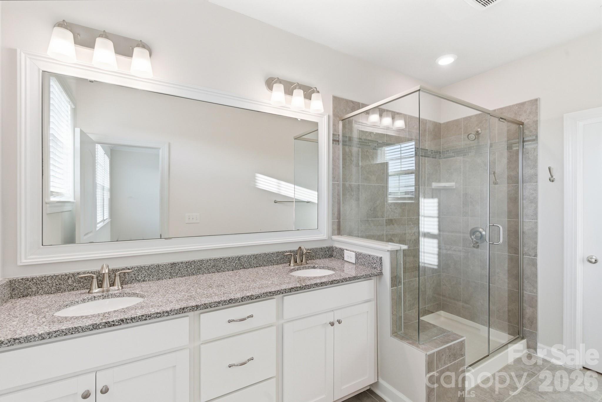 11515 Red Rust Lane Charlotte, NC 28277 - Photo 32 of 48 a bathroom with a granite countertop sink mirror and shower