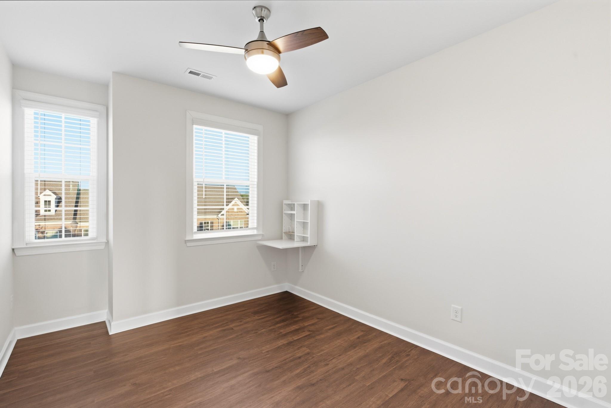 11515 Red Rust Lane Charlotte, NC 28277 - Photo 37 of 48 an empty room with wooden floor fan and windows