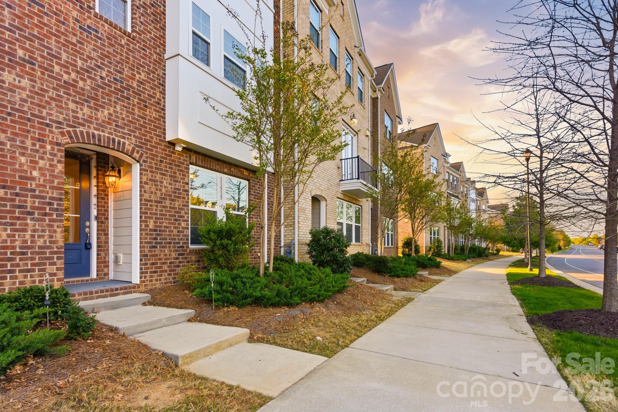 11515 Red Rust Lane Charlotte, NC 28277 - Photo 4 of 48 a view of a brick building next to a yard