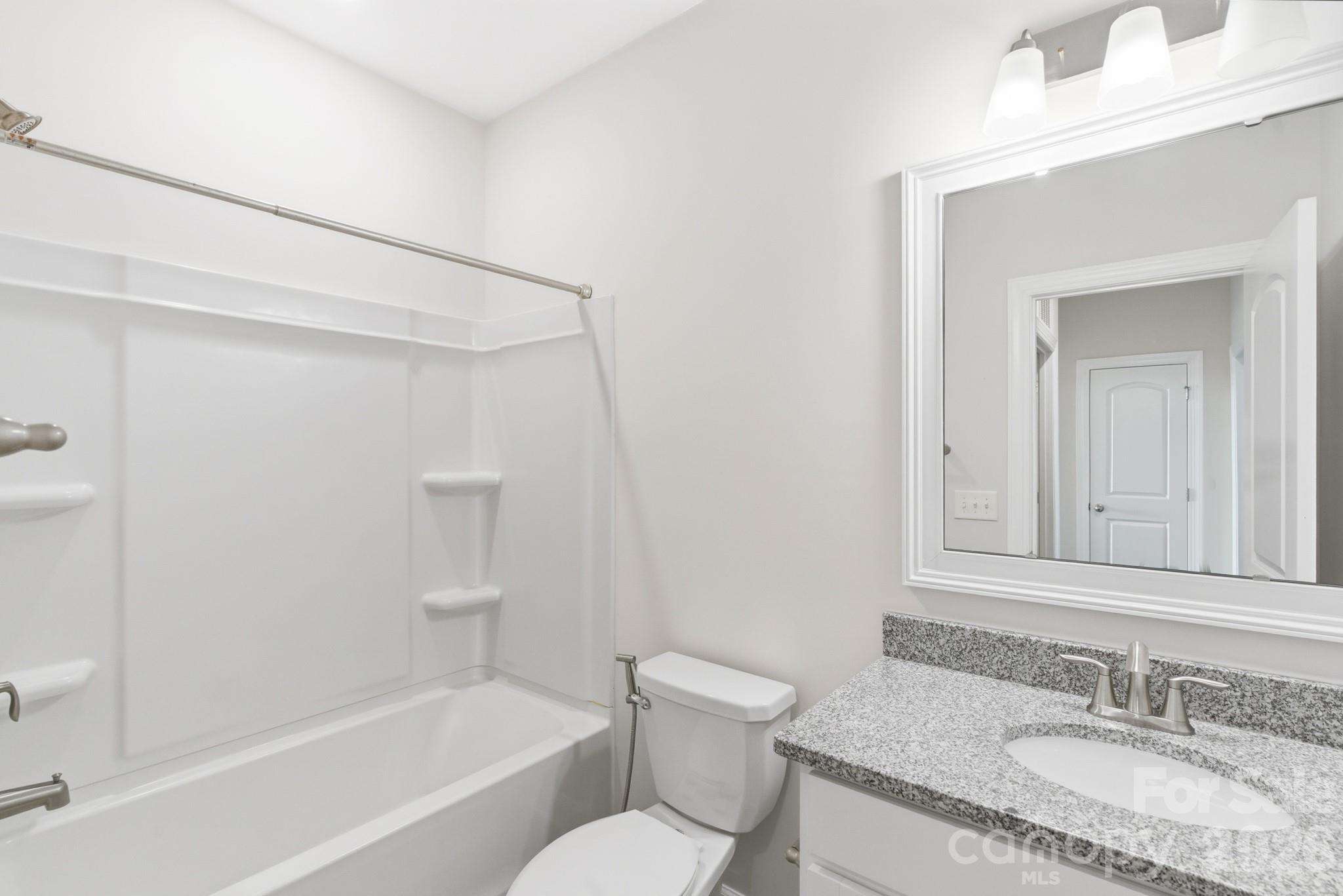 11515 Red Rust Lane Charlotte, NC 28277 - Photo 41 of 48 a bathroom with a granite countertop sink toilet and shower