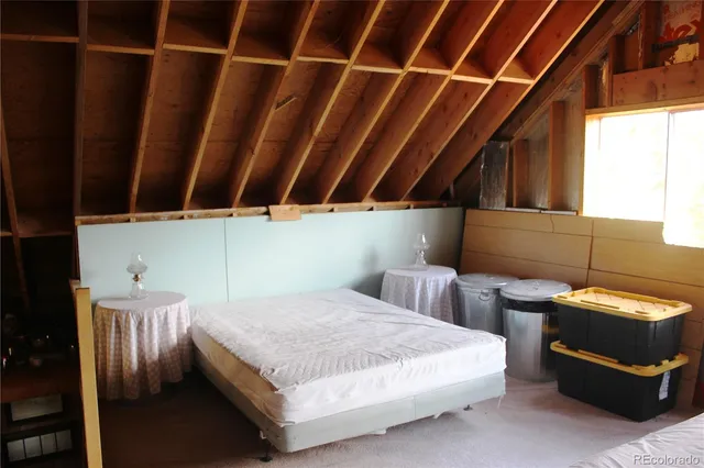 a bedroom with a bed and a cabinet
