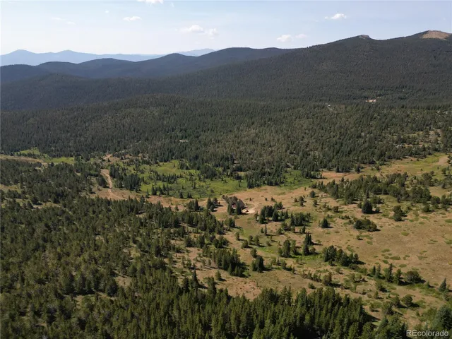 a view of a town with mountains in the background